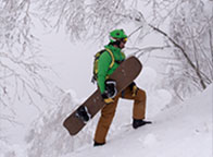 World champion snowboarder Seth Wescott climbs up a mountain slope.