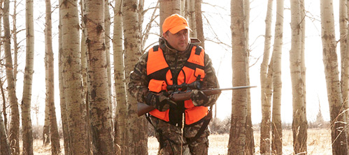L.L.Bean Outdoor Discovery Schools offer Maine Hunter Safety Courses. A big-game hunter with a scoped rifle moves quietly through a stand of trees. Classes fill fast, so sign up today.